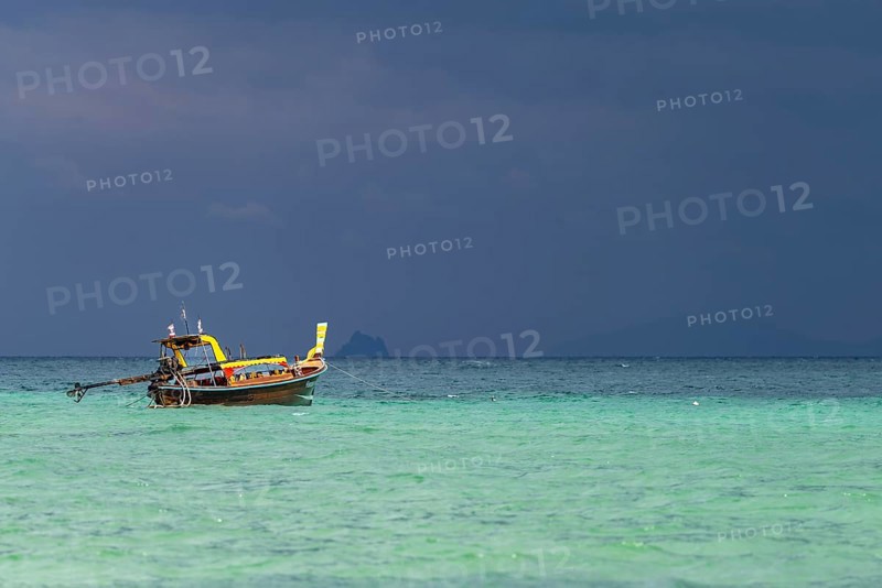 Longtail boat (Thai: Ruea Hang Yao) on the beach, behind it an approaching thunderstorm, Koh Ngai Island, Andaman Sea, Satun Province, Southern Thailand, Thailand