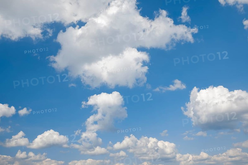 White cumulus clouds on the blue sky
