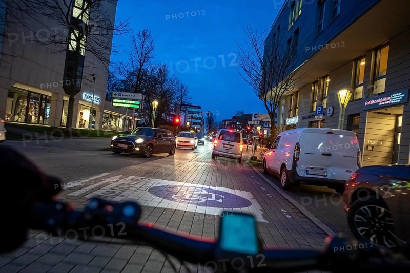 Cycling in the city, in the dark, in the evening, inner-city road, bicycle road, two-wheeler traffic has priority, 30 km/h zone, cyclist perspective, Essen, North Rhine-Westphalia, Germany