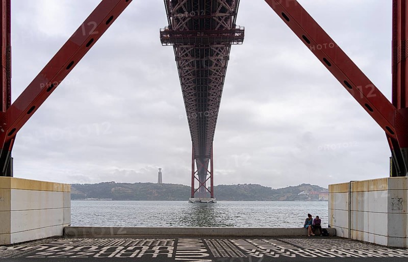 The Ponte 25 de Abril, 3.2 km long bridge in Portugal with a 2278 meter long suspension bridge across the Tagus, cloudy and rainy weather, third-longest suspension bridge with combined road and rail traffic, Lisbon, Portugal