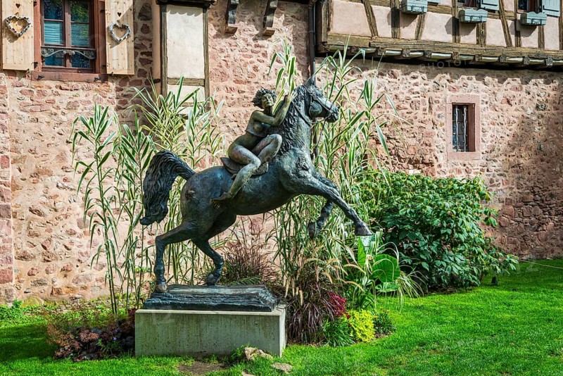 Statue of a woman riding with horse La Dame du Parc in Riquewihr
