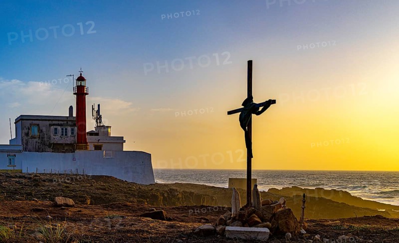 Religious scene, temporary Christian cross on the coast, Farol de Cabo Raso lighthouse, Sao Bras de Sanxete fortress, Cascais, PortugalFarol de Cabo Raso lighthouse, Sao Bras de Sanxete fortress, Cascais, Portugal
