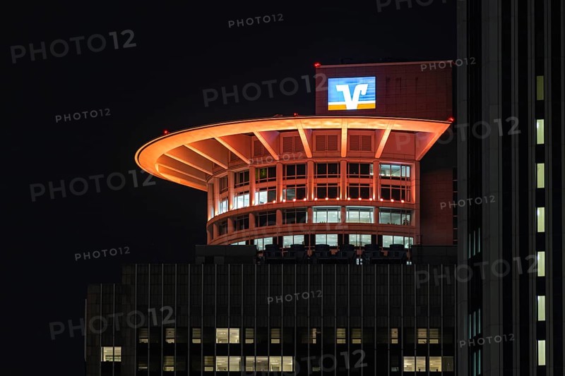 On the occasion of Orange Day, the international day against violence against woman on 25.11.2025, numerous buildings on the banking skyline in Frankfurt am Main were illuminated in orange, including the DZ Bank Tower, Frankfurt am Main, Hesse, Germany Germany