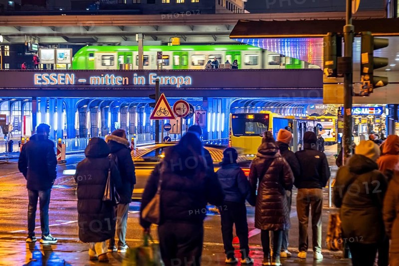 The main train station in Essen, blue illuminated underpass, bus station, am Europaplatz, train on the platform, pedestrian crossing, North Rhine-Westphalia, Germany