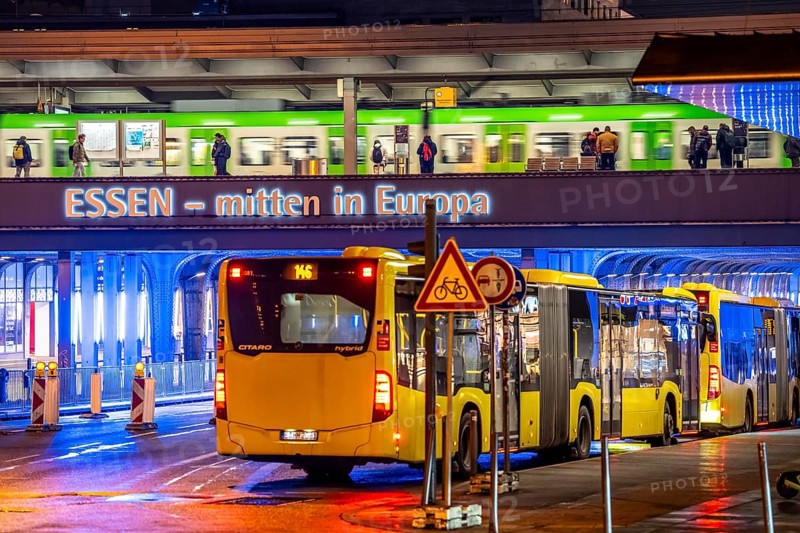 The main train station in Essen, blue illuminated underpass, bus station, am Europaplatz, train on the platform, North Rhine-Westphalia, Germany
