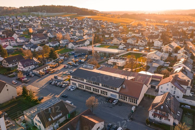 Aerial view of a village at sunset with golden autumn lights and hills in the background, Morof Althengstett, Calw district, Germany