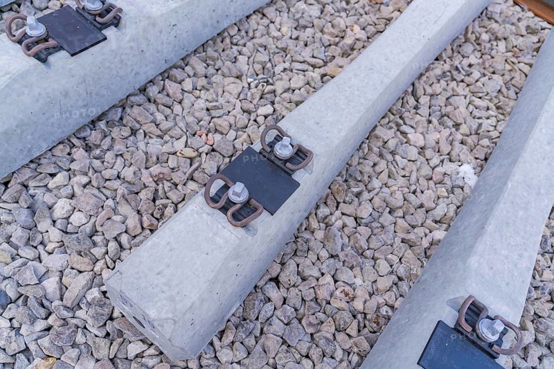 Detailed view of concrete sleepers and their metal fastenings on gravel, track construction of the Hermann Hesse Railway, Calw, Germany