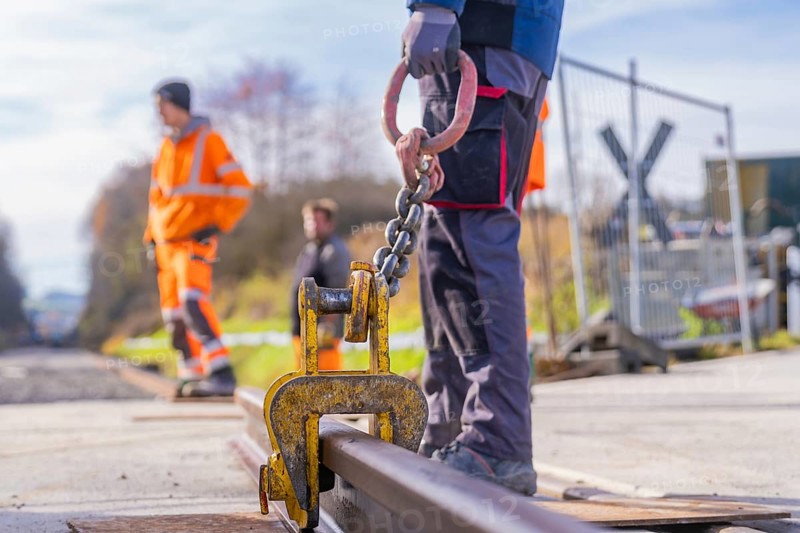 Close-up of a hook on a rail, workers in the background, track construction, Hermann Hesse Railway track construction, Calw, Germany