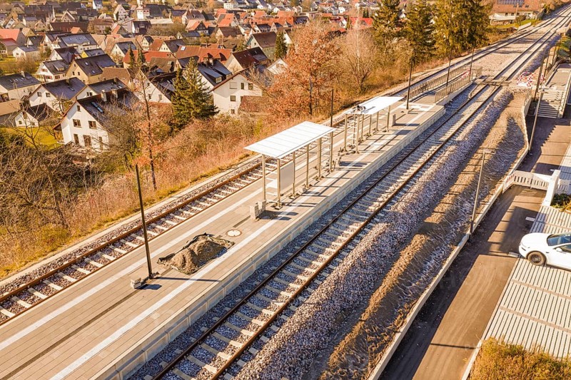 Station with two tracks in a small village surrounded by autumn trees, new Hermann Hessebahn station, Ostelsheim, Calw district, Germany