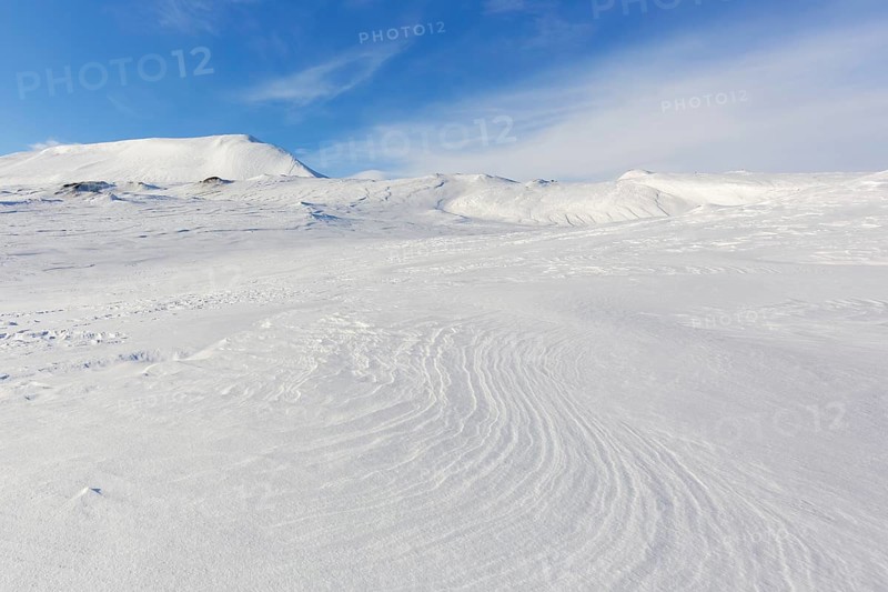 Desolate windswept snow covered Arctic landscape at Mohnbukta, bay at the western shore of Storfjorden in Sabine Land at Spitsbergen, Svalbard