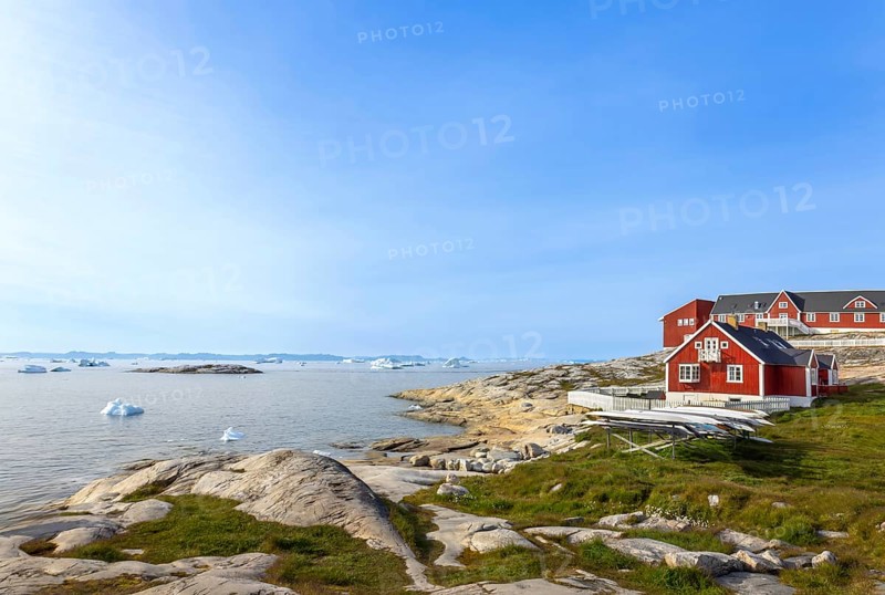 Typical architecture of Greenland Ilulissat with colored houses located near fjords and icebergs
