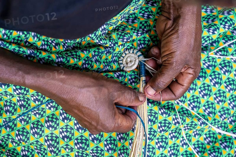 Local woman weaving baskets from papyrus, near Fort Portal, Uganda