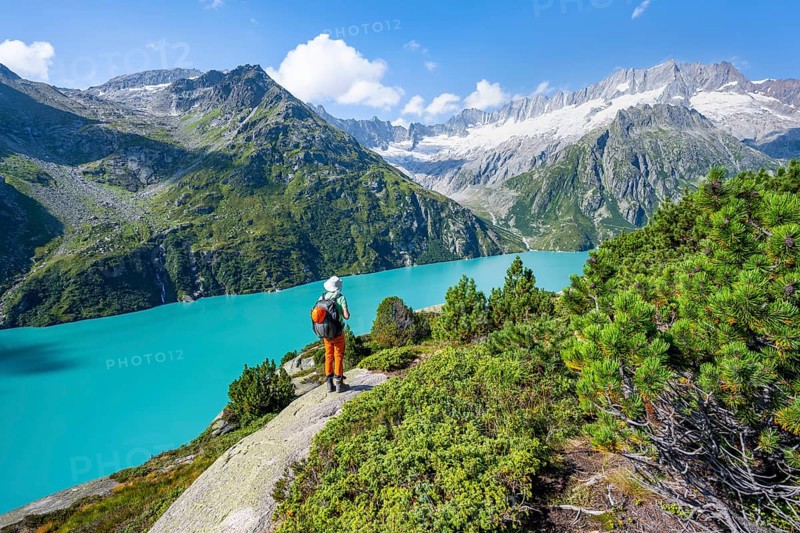 Mountaineers in front of picturesque mountain landscape, turquoise-blue mountain lake Göscheneralpsee, Dammastock and Damma Glacier, Göscheneralp, Canton of Uri, Switzerland