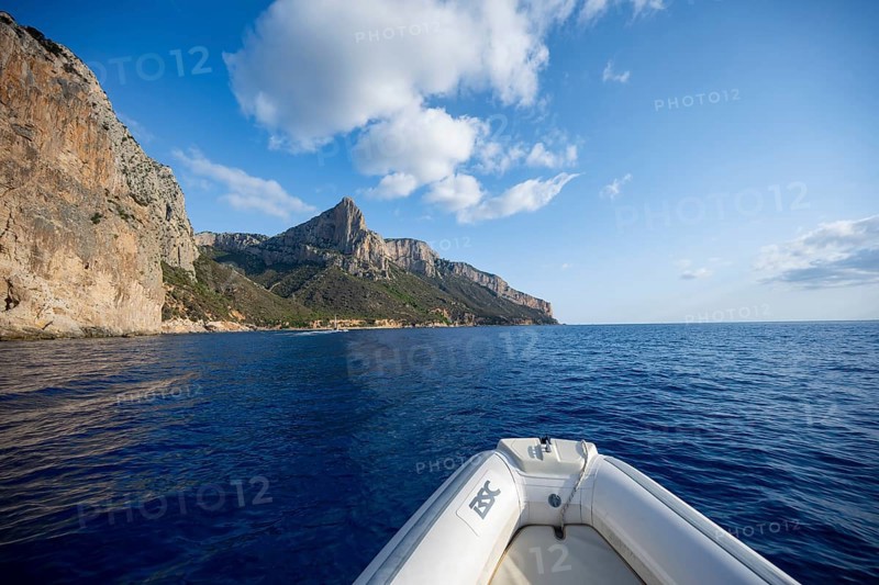 Motorboat trip along the picturesque rocky coast, cliffs and blue sea, Golfo di Orosei, Baunei, Sardinia, Italy