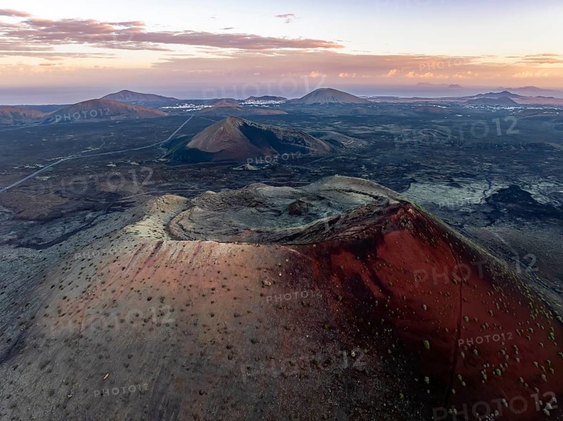 Caldera Colorada volcano, picturesque volcanic landscape with volcanic crater at sunrise, Parque Natural de Los Volcanes, aerial view, Lanzarote, Canary Islands, Spain
