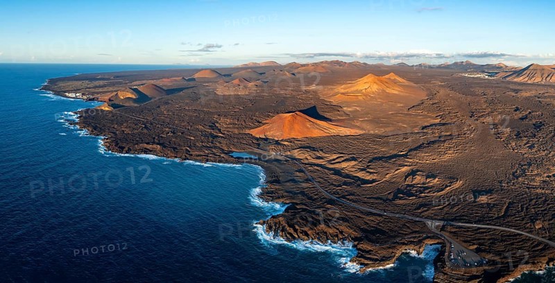 Coast with lava fields, volcanic landscape near Los Hervideros with red volcano Montaña Bermeja, in the evening light, aerial view, Lanzarote, Canary Islands, Spain