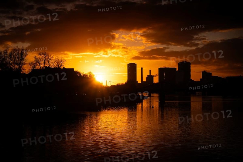 The sun sets behind the Main and Frankfurt Westhafen Tower, Alte Brücke, Frankfurt am Main, Hesse, Germany