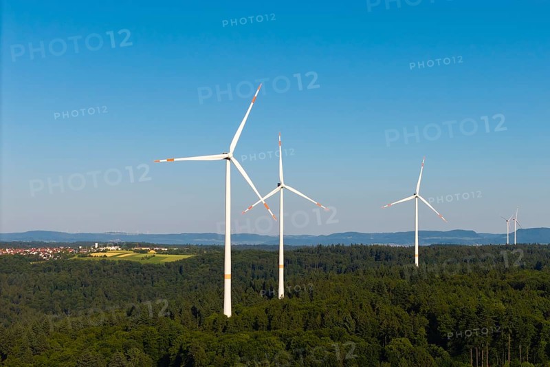 Wind power plants in a wooded area under a bright blue sky, near Schorndorf, Remstal, Baden-Württemberg, Germany