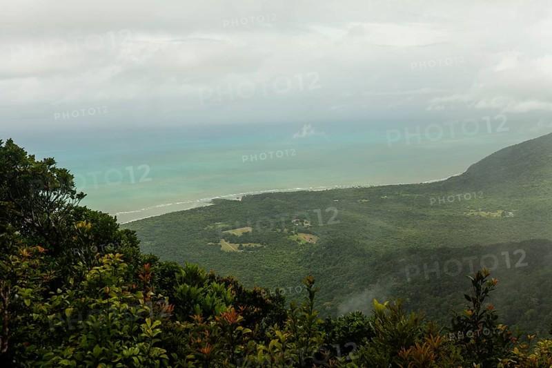 Distant tropical view from Mount Sorrow across valley and bay to where the Great Barrier Reef meets the coast Queensland, Australia