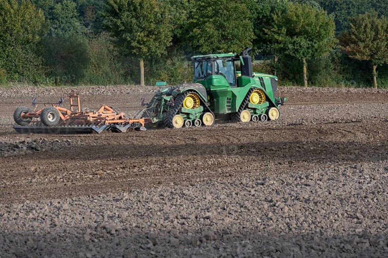 Crawler tractors harrow the field, Othenstorf, Mecklenburg-Western Pomerania, Germany