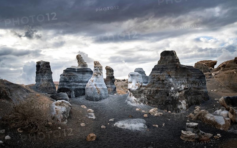 Eroded rock formations, volcanic landscape with dramatic cloudy skies, Ciudad Estratificada or Los Roferos, Antigua Rofera de Teseguite, Lanzarote, Canary Islands, Spain