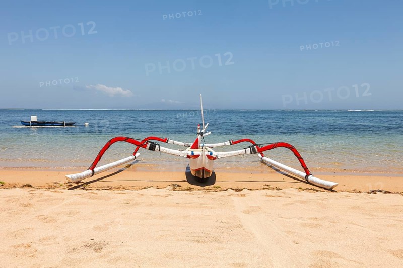 Colourfully painted outrigger fishing boats, (Junkung), on Sanur beach, Bali, Indonesia