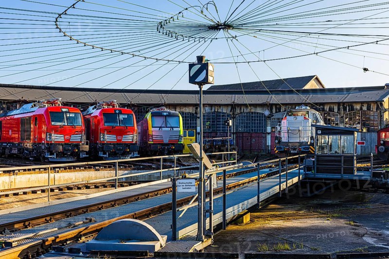 Turntable and overhead line spider, behind it modern locomotives of the Austrian Federal Railways, ÖBB, and Deutsche Bahn, DB, parked in front of the old lock shed, Augsburg railway park, administrative district of Swabia, Bavaria, Germany
