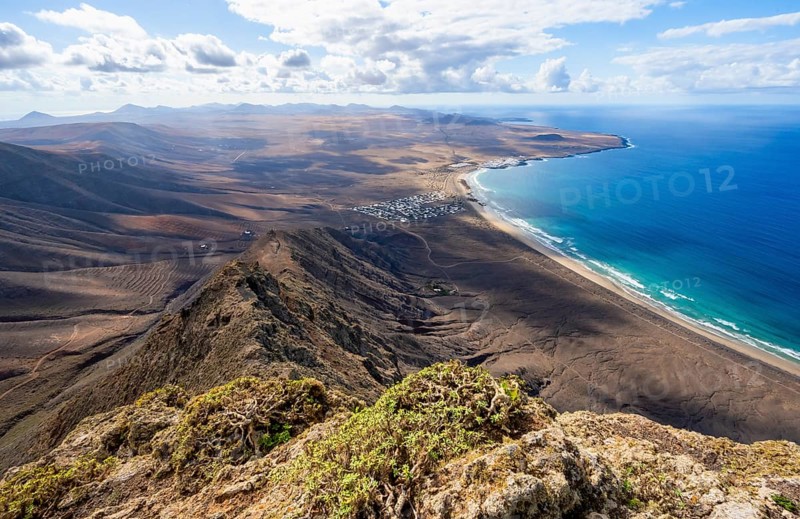 Castillejo viewpoint, view from the Risco de Famara cliffs to the coast and the sea with Famara beach, Playa de Famara with La Calaeta, Lanzarote, Canary Islands, Spain