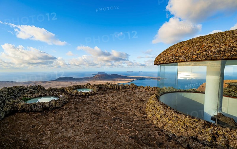 Stairway and viewing platform at the Mirador del Río viewpoint, in the evening light with sun stars, designed by artist César Manrique, view of the island of La Graciosa, Lanzarote, Canary Islands, Spain