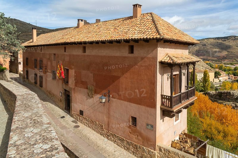 Alberque hostel building with flags flying, historic buildings in medieval village of Albarracín, Teruel province, Aragon, Spain