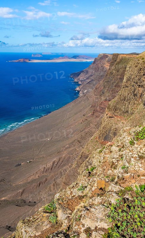 Castillejo viewpoint, view from the Risco de Famara cliffs to the coast and the sea with the Famara beach, Playa de Famara, Lanzarote, Canary Islands, Spain