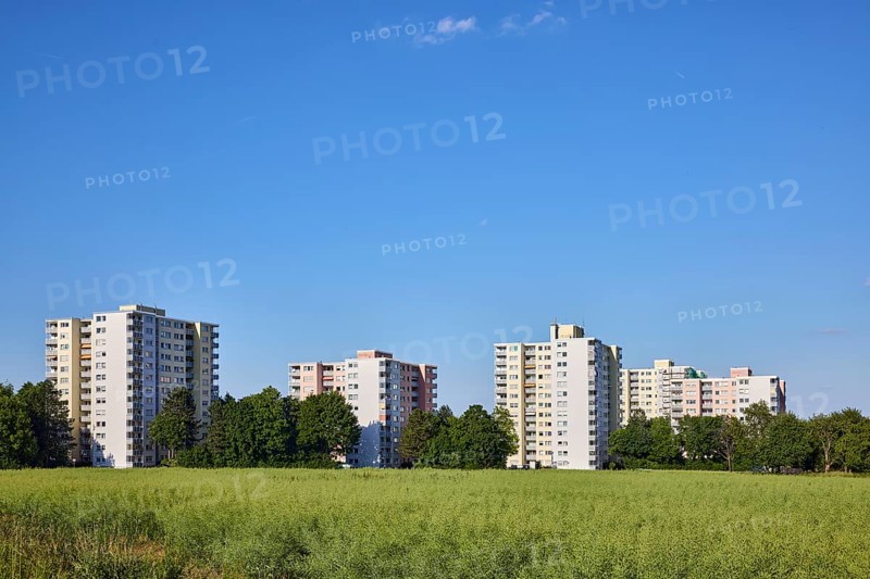 View of skyscrapers on Niederhöchstädter Straße, residential buildings, trees, cultivated landscape, field, oilseed rape (Brassica napus), blue sky, cumulus clouds, Steinbach, Taunus, Hochtaunus, Hesse, Germany