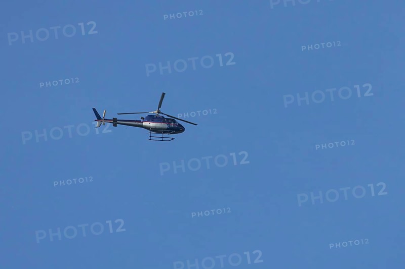 Airbus H125 helicopter flying in a blue sky, England, United Kingdom