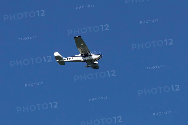 Cessna 172C Skyhawk aircraft flying in a blue sky, England, United Kingdom
