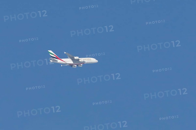 Airbus A380 jet passenger aircraft of Emirates airlines flying in a blue sky, England, United Kingdom
