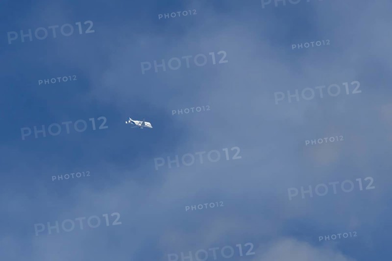 Airbus A330-743L Beluga XL cargo jet aircraft flying in a blue sky with white clouds, England, United Kingdom