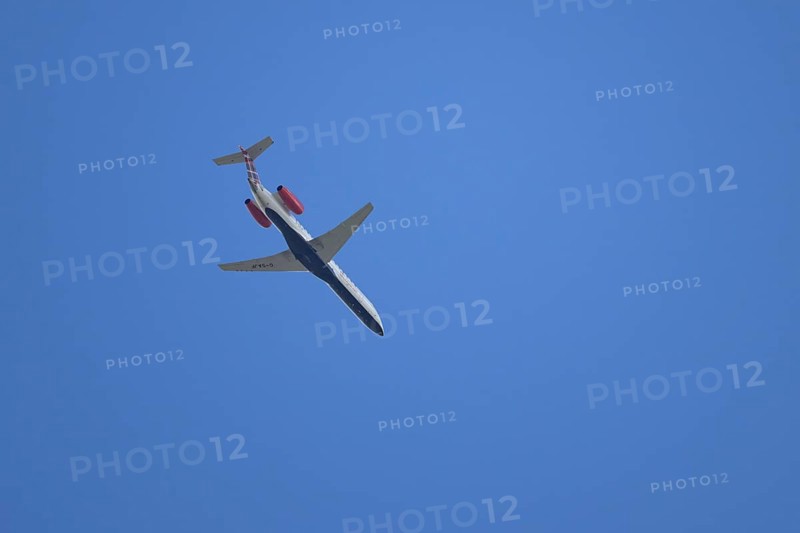 Embraer ERJ-145 jet passenger aircraft of Loganair airlines flying in a blue sky, England, United Kingdom
