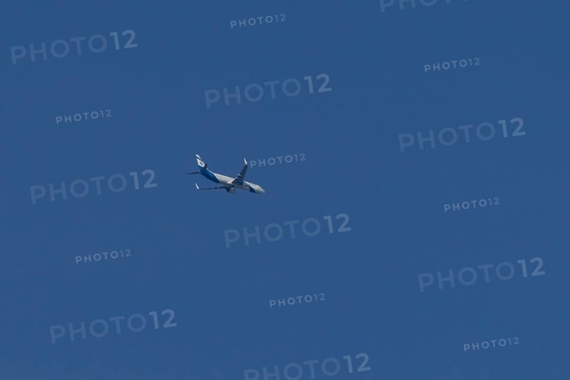 Boeing 737 jet passenger aircraft of El Al Israel airlines flying in a blue sky, England, United Kingdom