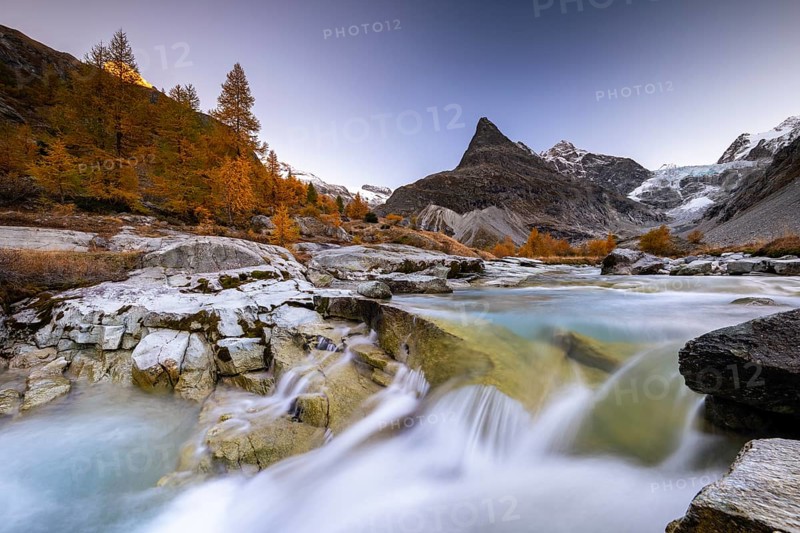 Mountain stream with autumnal larches and mountain views, Mont Mine, Ferpecle glacier, Val d'Herens, Canton of Valais, Switzerland