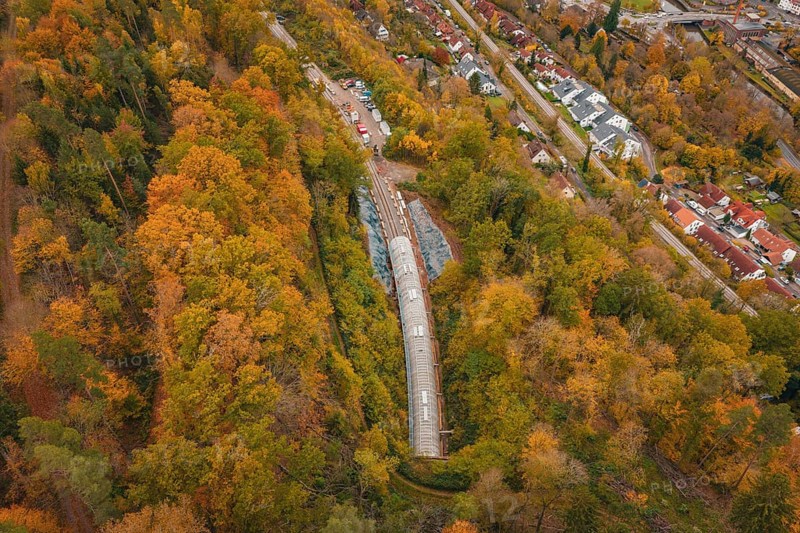 City panorama with view of a train tunnel in an autumnal forest, Hermann-Hesse-Bahn construction site, Calw, Germany