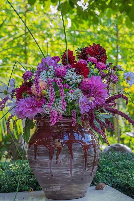 A colorful bouquet of flowers in a decorative vase in the garden, North Rhine-Westphalia, Germany