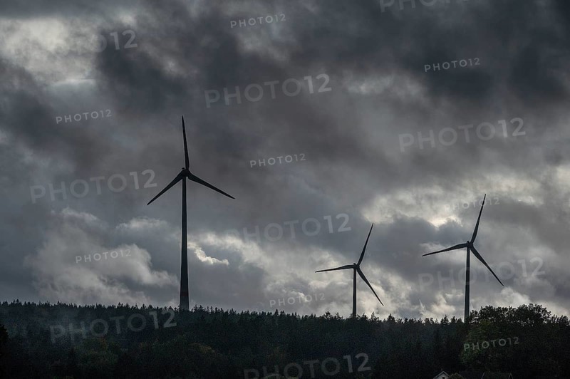 Wind turbines in pine forest during thunderstorm, Bavarian Forest, Bavaria, Germany