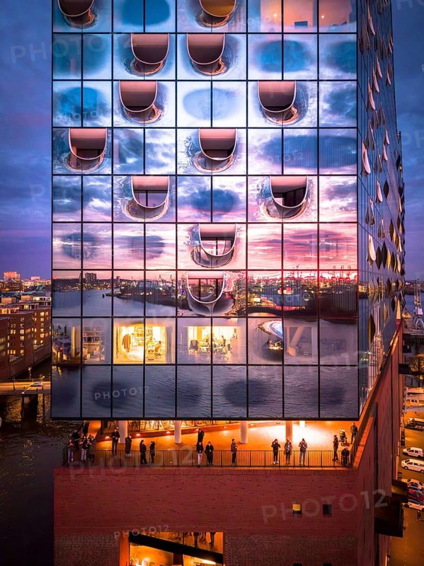 Aerial view of the Elbe Philharmonic Hall with reflections on the façade in the evening light above the harbor, Hamburg, Germany