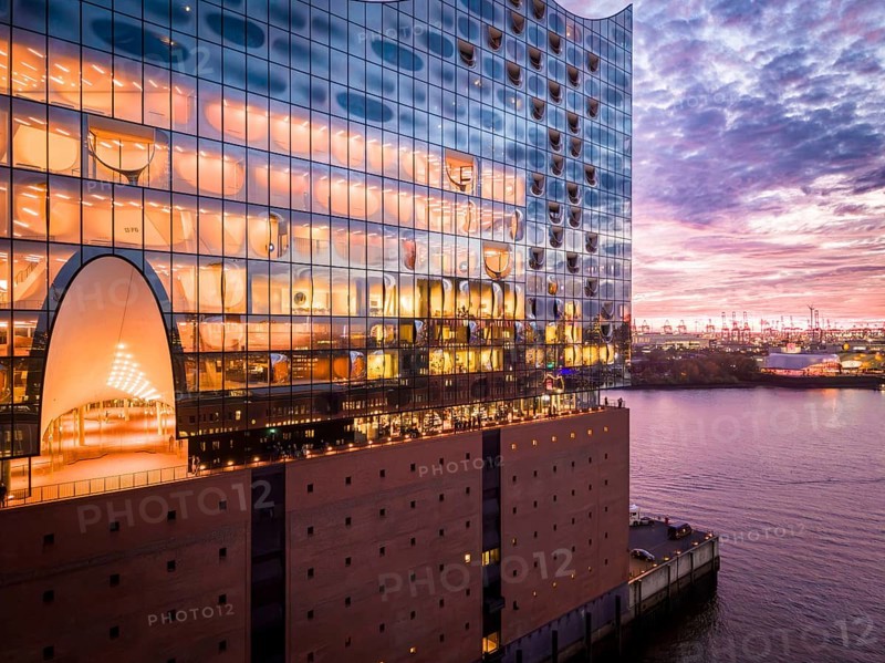 Aerial view of the Elbe Philharmonic Hall with reflections on the façade in the evening light above the harbor, Hamburg, Germany