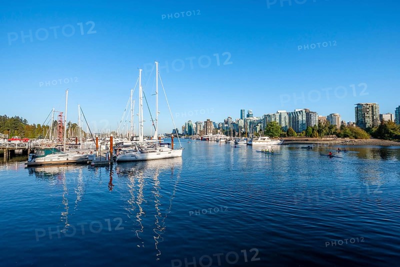 Skyscrapers and sailboats in the marina, Vancouver skyline reflected in the ocean, Coal Harbour, Downton Vancouver, British Columbia, Canada