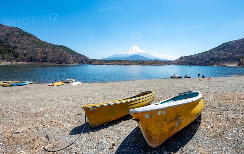 Rowing boats on shore, view across the lake to Mt Fuji volcano, Motosu Lake, Yamanashi Prefecture, Japan