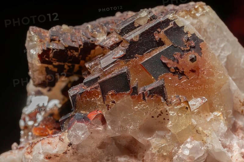 Transparent crystals sit on rocks and reveal their unique shimmer and geological structure. The light underlines the natural beauty of the minerals.Bas Rhin, Alsace, France