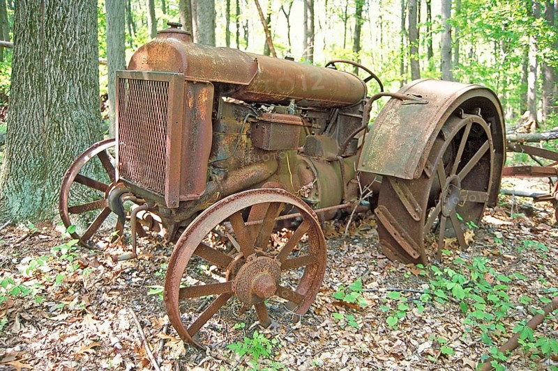 Rusted American Fordson tractor with iron tires around 1900, deposited in a wooded area, Marksboro, New Jersey, USA