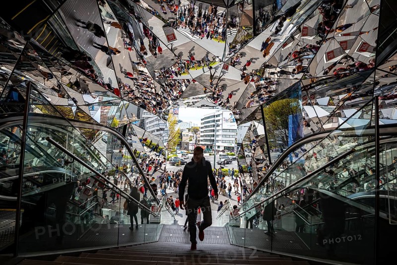 Young man on a stairway, entrance to a shopping center with many mirrors, Tokyu Plaza Omotesando Harajuku, modern architecture, Tokyo, Japan