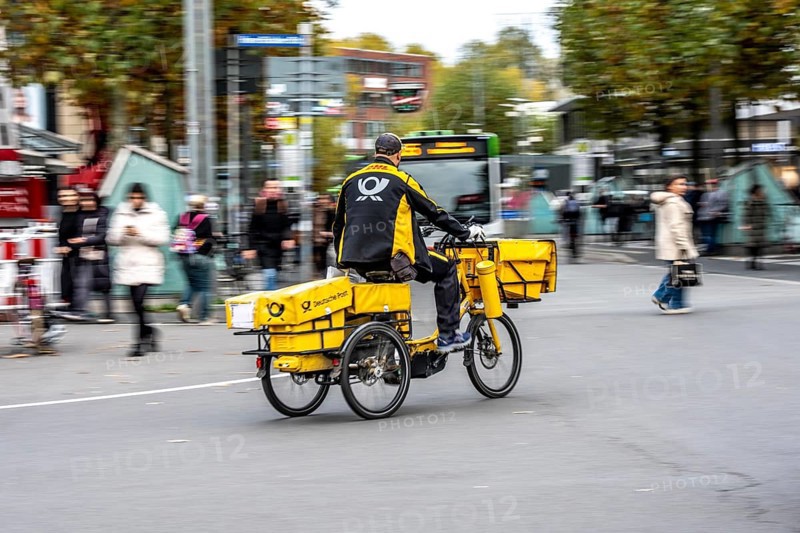 Delivery agent, Deutsche Post mailman on e-bike, Bochum, North Rhine-Westphalia, Germany